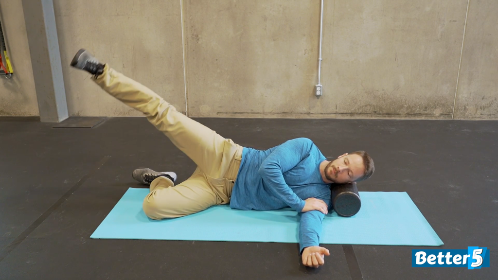 Senior performing lateral leg lifts with a straight top leg on a mat, demonstrating one of the 10 exercises to prevent falls.