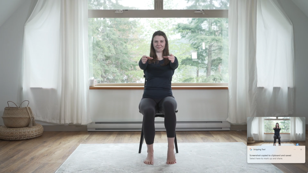 With her arms out in front of her the instructor pushes through her toes with her other foot to raise her heel as she brings her other foot back down to lay flat.