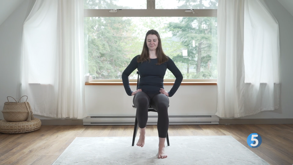The coach extends her raised foot out in front of her while keeping it flexed, the proper form to get the most impact from this seated leg exercise.