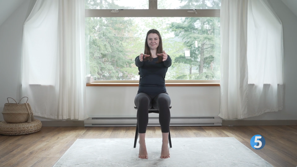 With her arms out in front of her the fitness instructor pushes from her toes to raise her heels off the ground, to complete one rep of 8 for this seated leg exercise.