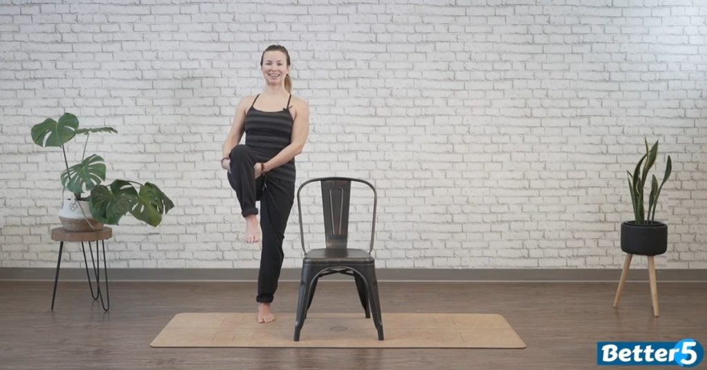 fitness instructor demonstrating gentle at-home stretching exercise for mobility and flexibility