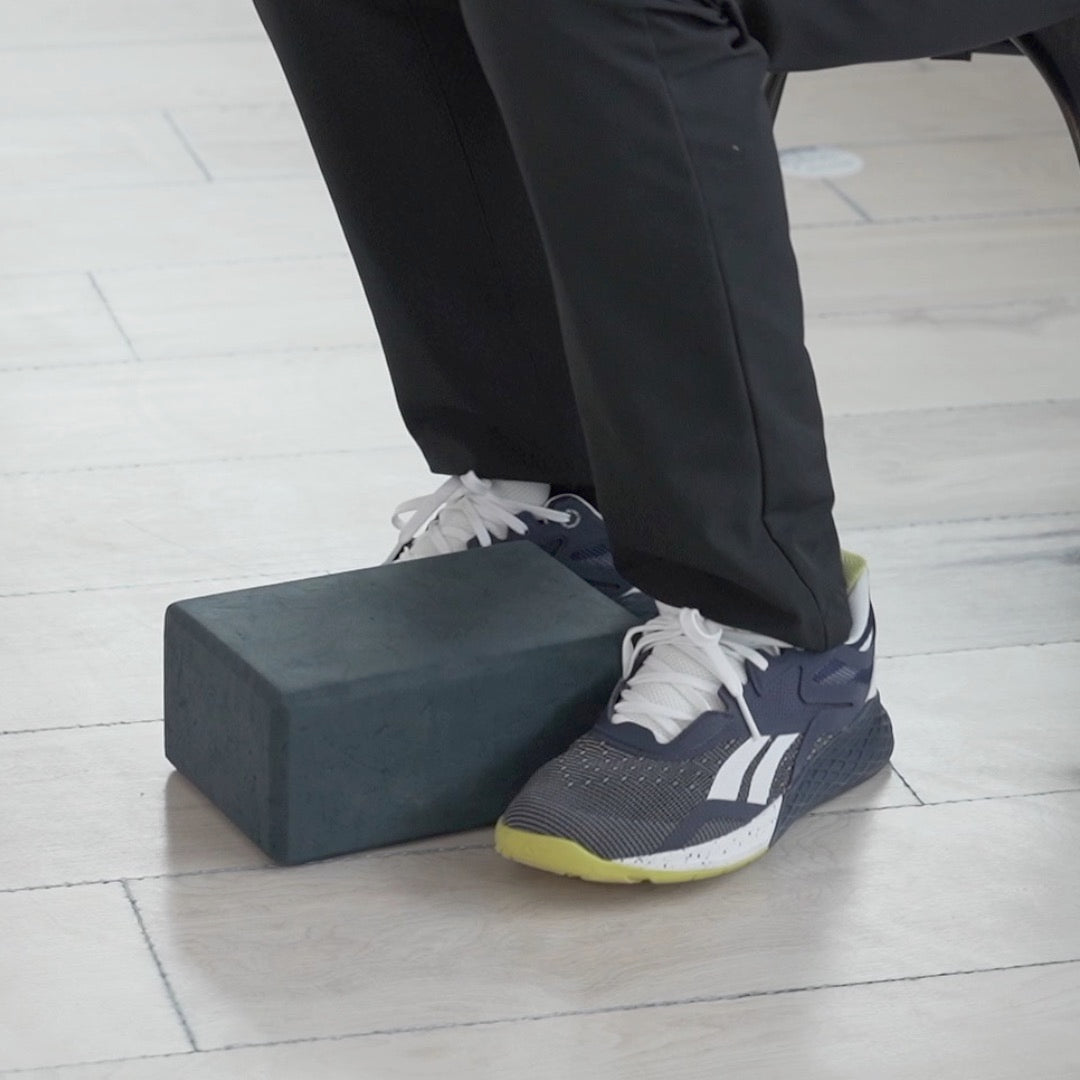 Instructor demonstrating foot strengthening and balance exercises for older adults at home to improve stability and mobility