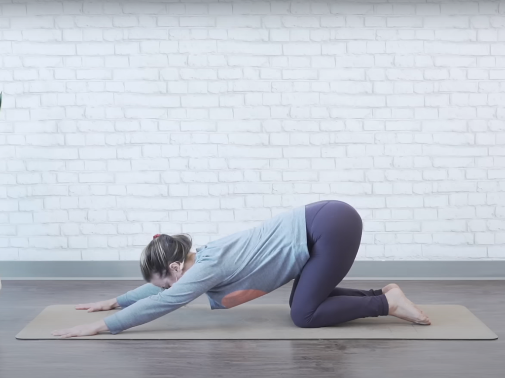 Demonstrating the praise-the-ground bed exercise - ending position
