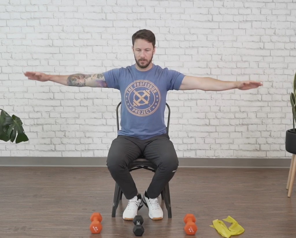 Fitness instructor demonstrates how to perform seated arm circles, one of the best arm exercises for seniors