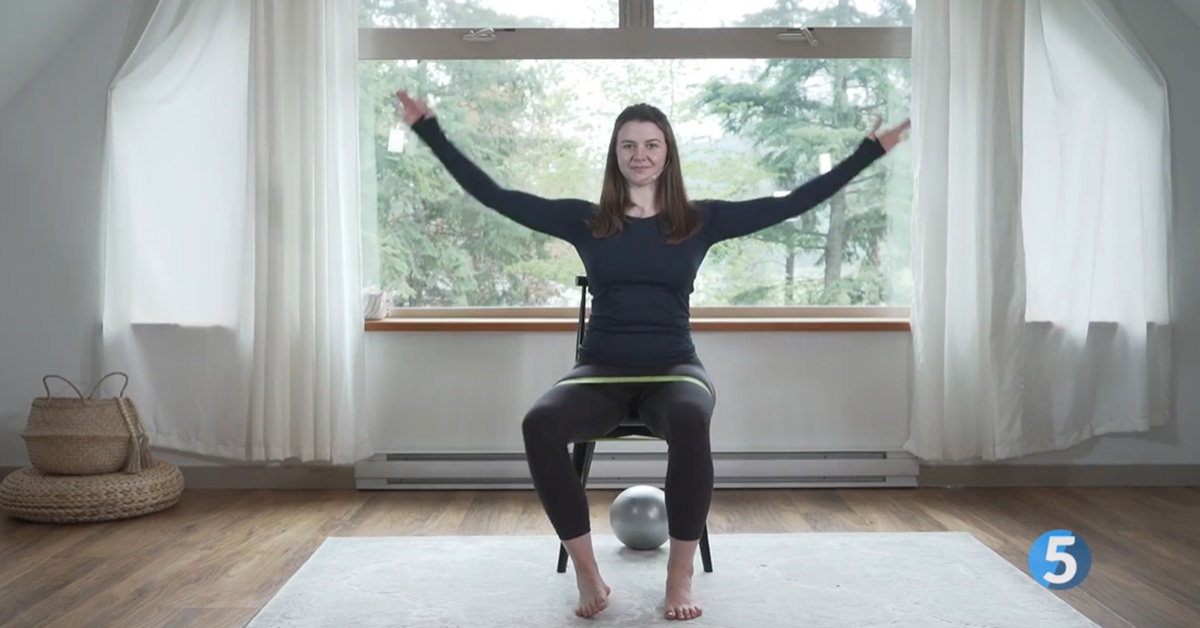 instructor doing seated pilates for lower body strength