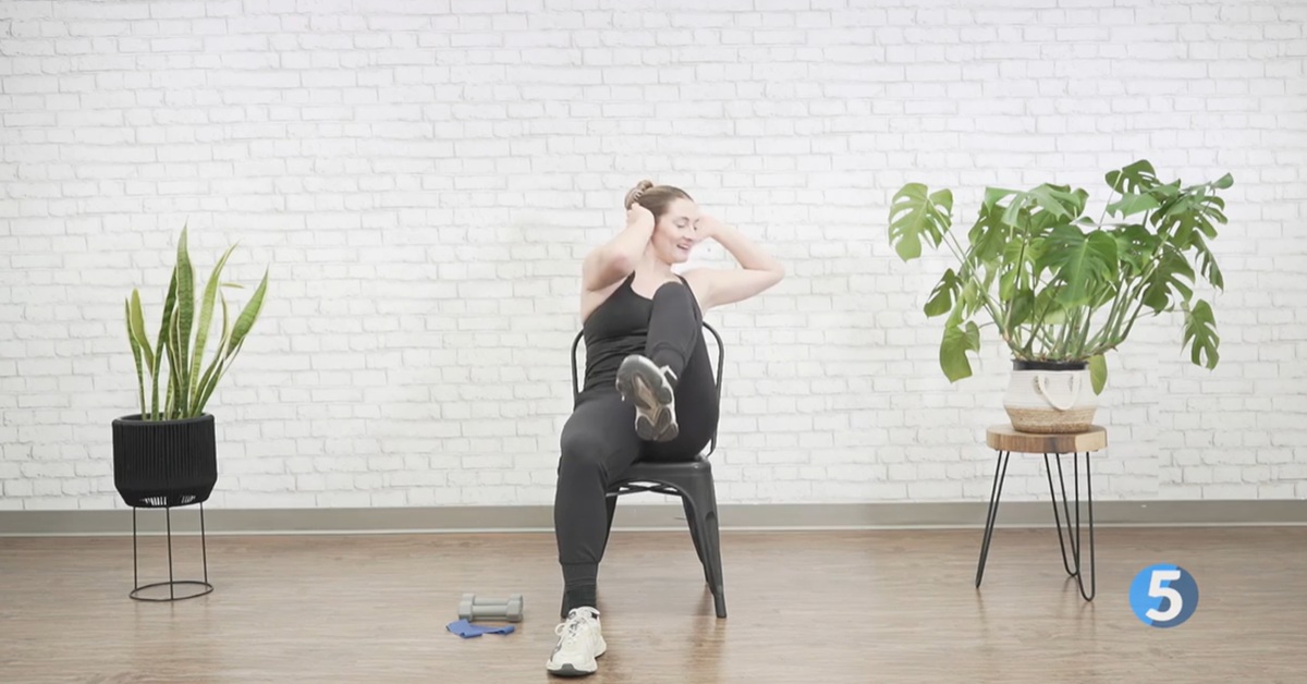 instructor doing seated seniors at home workout