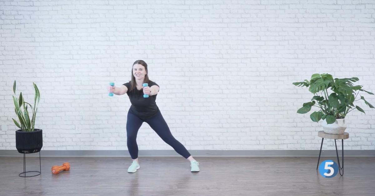 instructor demonstrating indoor strength workout for women over 40