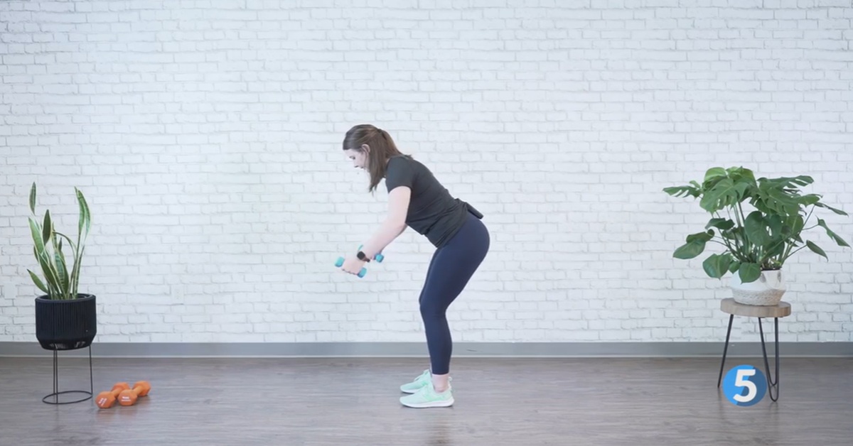 instructor demonstrating indoor strength workout