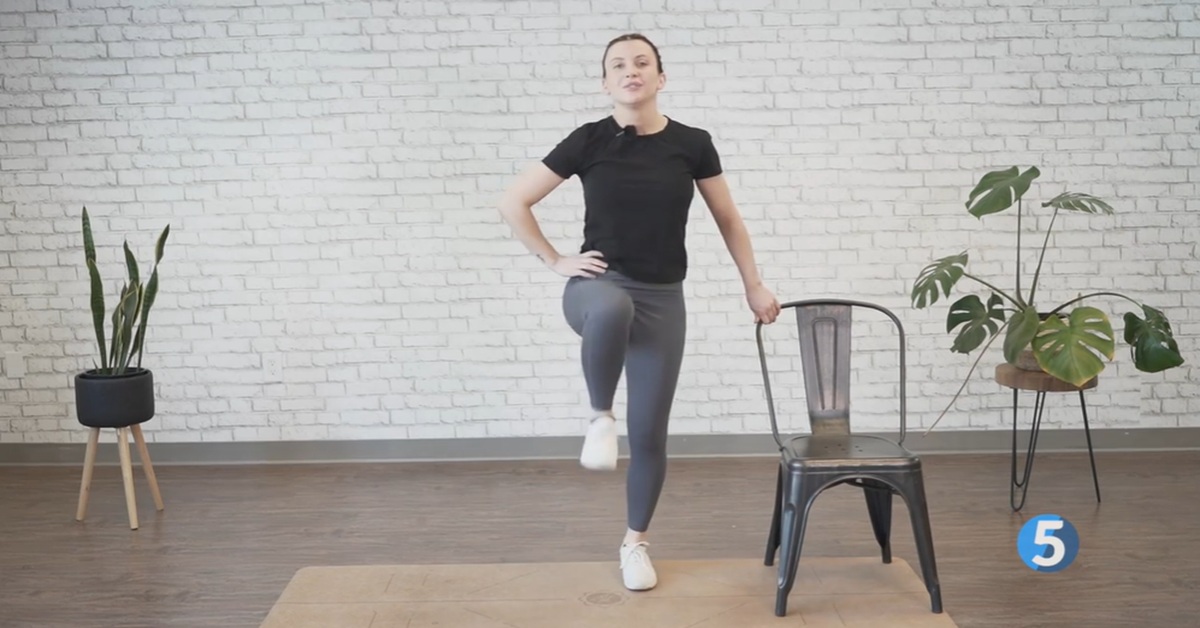 instructor demonstrating indoor marching workout