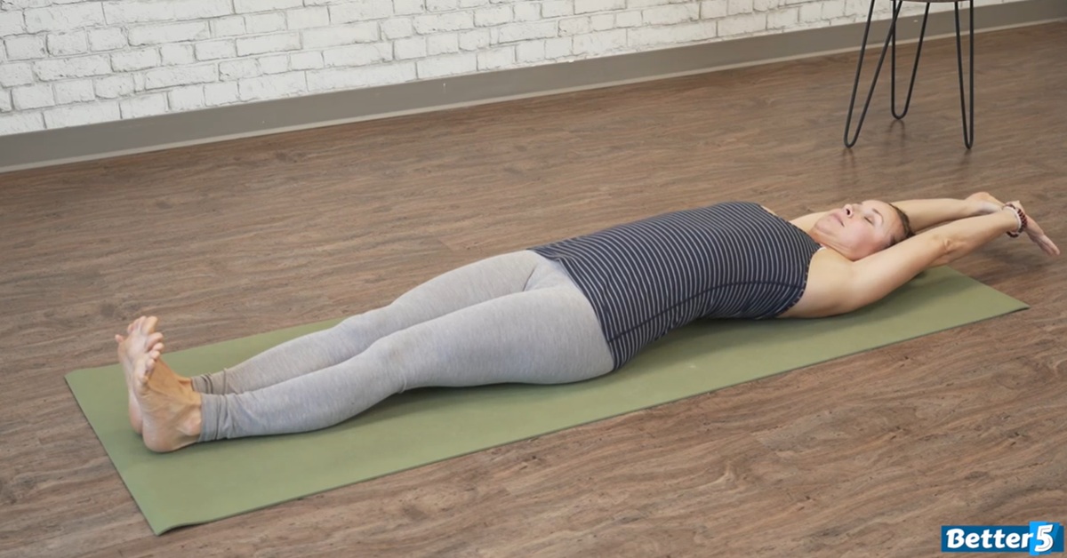 instructor doing an at home yoga excercise for seniors