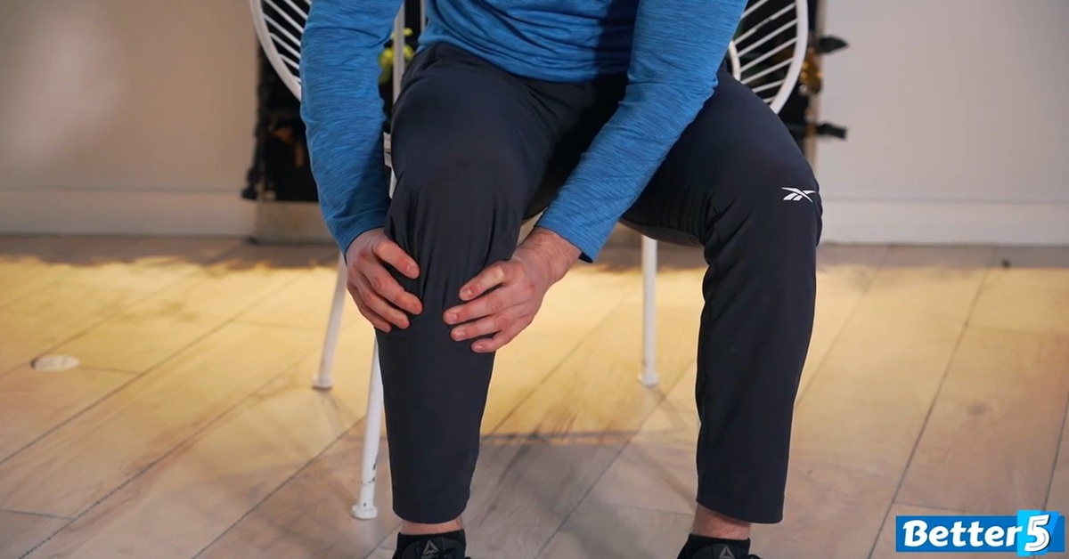 instructor performing seniors knee strengthening excercise