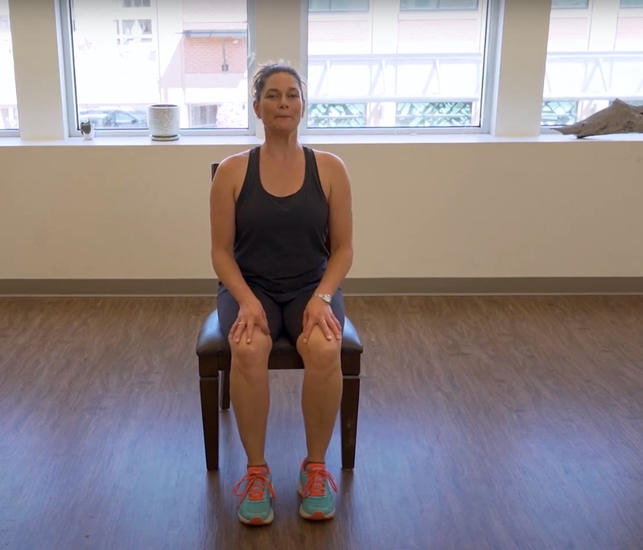 Instructor demonstrates sit-to-stand technique as part of exercises for osteoporosis of the hip