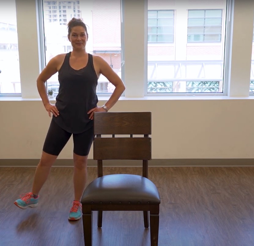Woman demonstrates hip abduction, one of the simplest exercises for osteoporosis of the hip