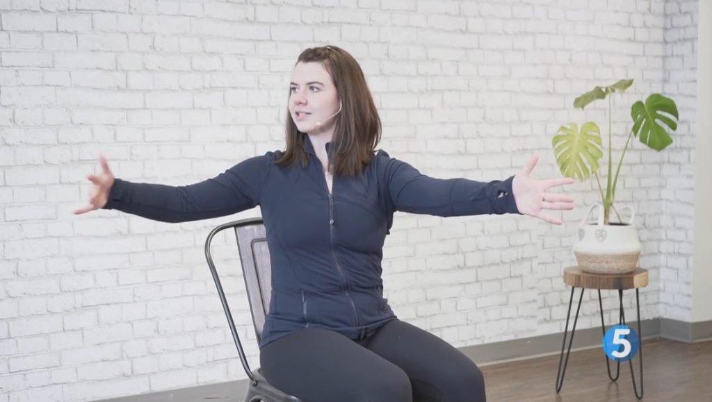 Instructor doing an easy exercise at home designed for seniors