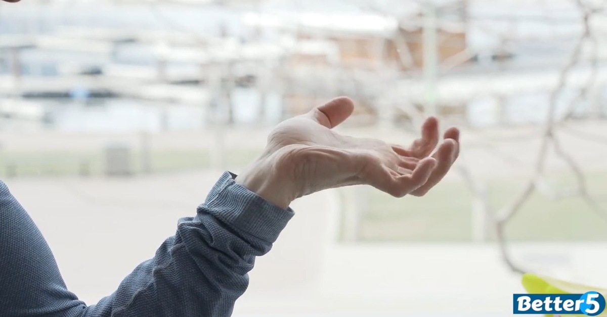 instructor demonstrating hand and grip strength excercise