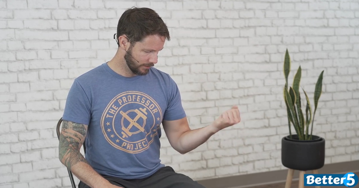 instructor demonstrating hand strengthening excercise