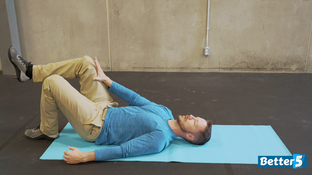 The fitness instructor lays on his back with a bent leg pushing against his hand to create resistance, getting the best part of this mobility exercise by strengthening his hip flexors.