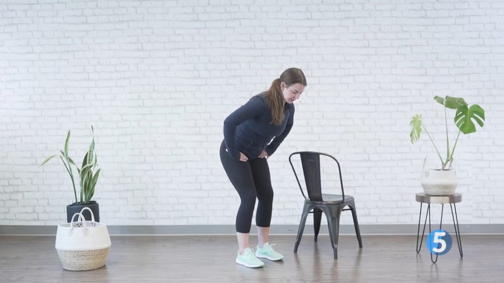 instructor doing gentle hip stretches at home