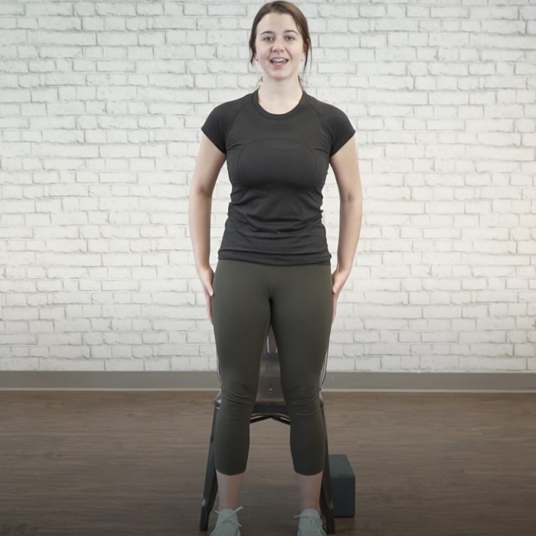 Instructor stands in the starting position for squats as part of pelvic floor therapy at home.