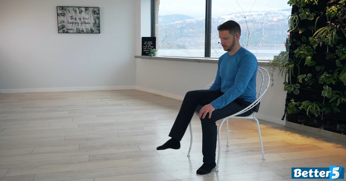 instructor doing seated knee strengthening excercise for seniors
