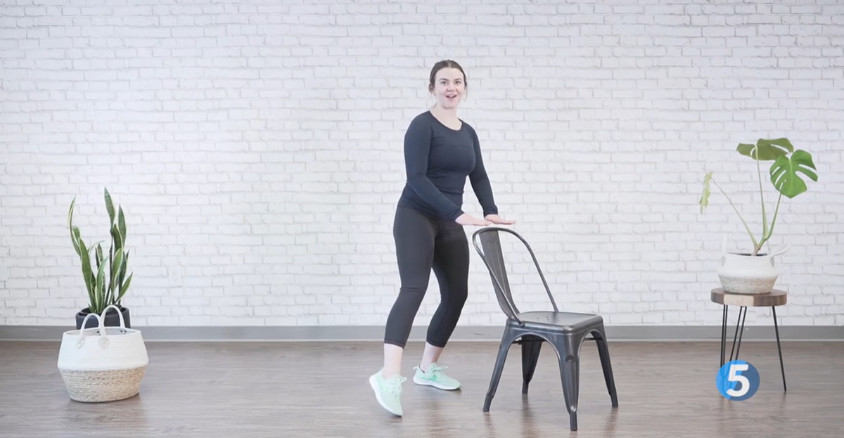 instructor performing side step excercise for seniors