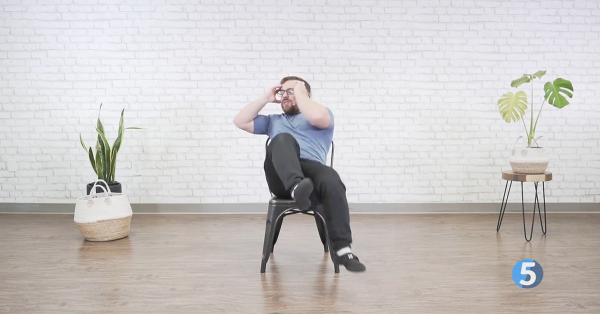 instructor performing seated core excercise for seniors