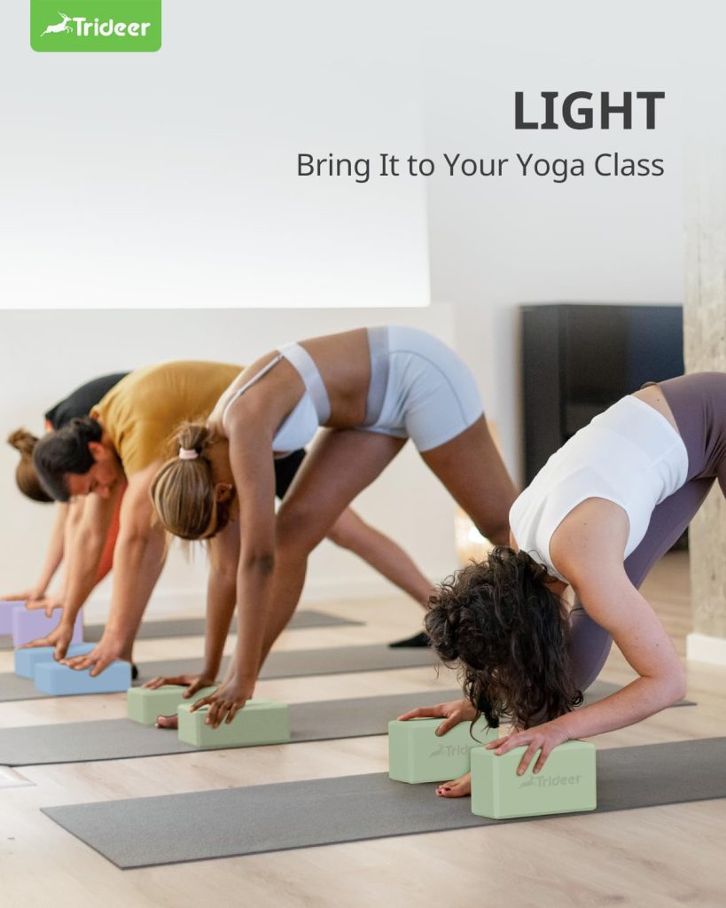 A group performs forward bends while using yoga blocks for support.