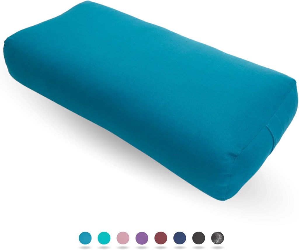 Teal-coloured rectangular yoga bolster on a plain background