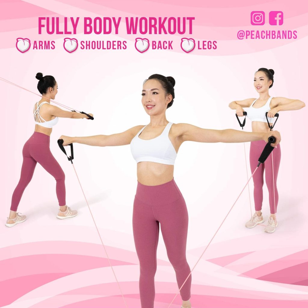 Lady in athletic wear stretching with a resistance band with handles