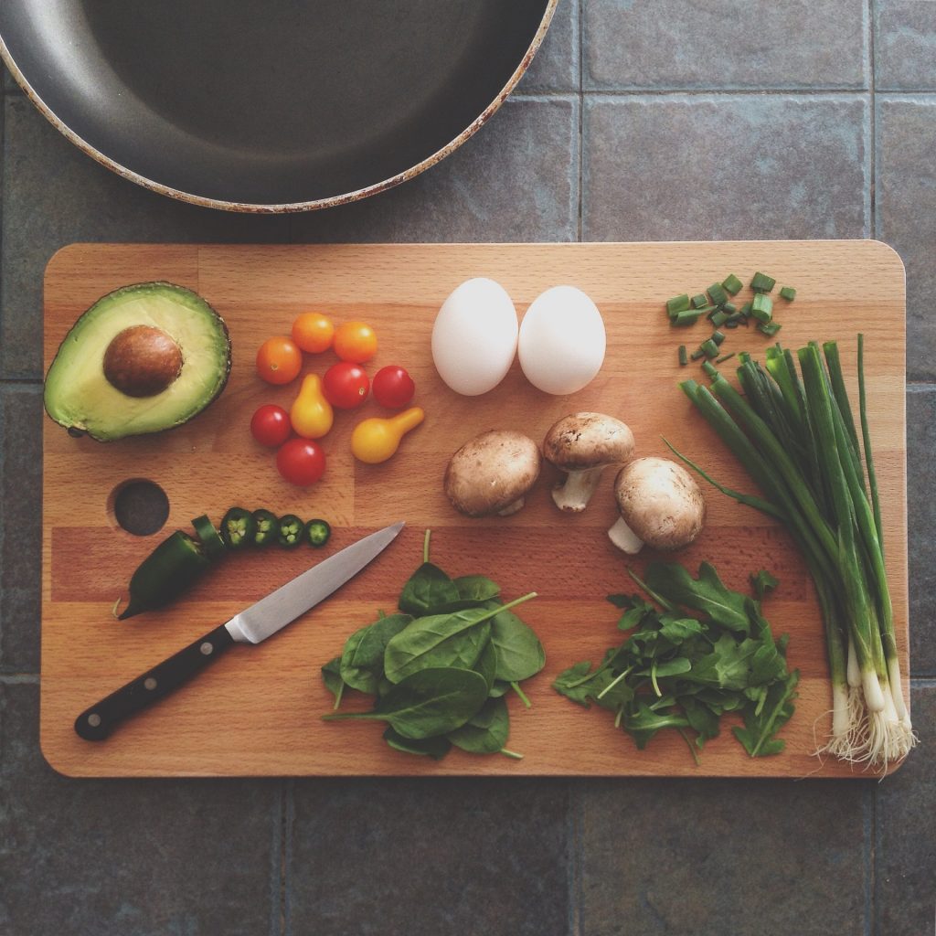 Perimenopause-friendly foods, including eggs and avocado on a chopping board