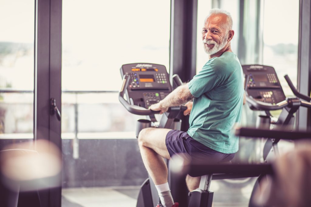 senior on stationary bike for cardio health