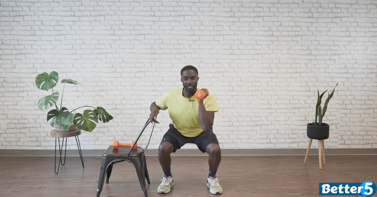 instructor doing chair assisted strength excercise