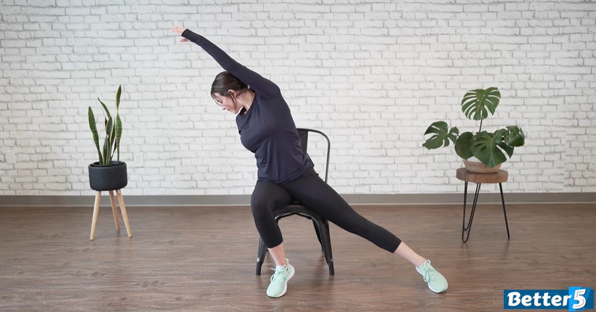 instructor performing a gentle seated excercise for older adults