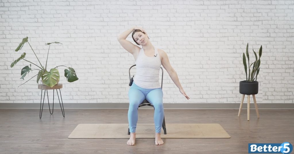 Instructor doing neck and shoulder stretches for seniors indoors 