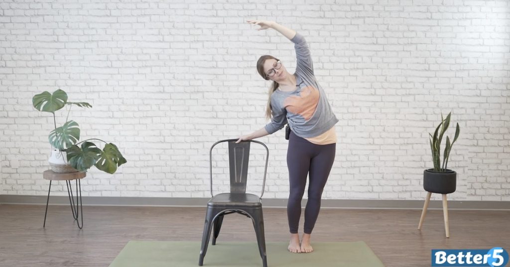 Instructor doing balance and standing exercises for seniors at home