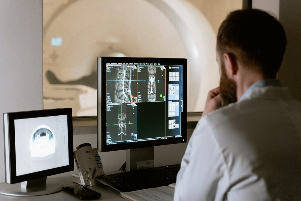 Doctor looking at bone density test results for older patient
